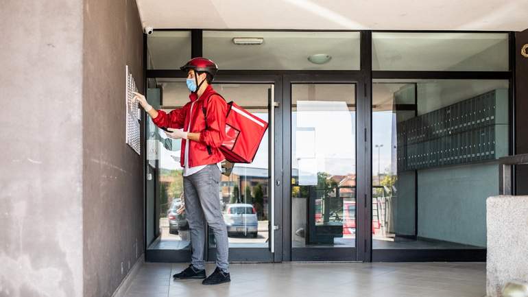 Delivery driver ringing apartment buzzer