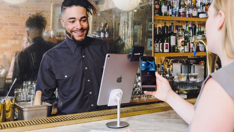 bartender cashing out a customer using iPad POS