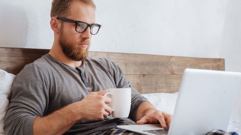 restaurant owner looking at reports on laptop