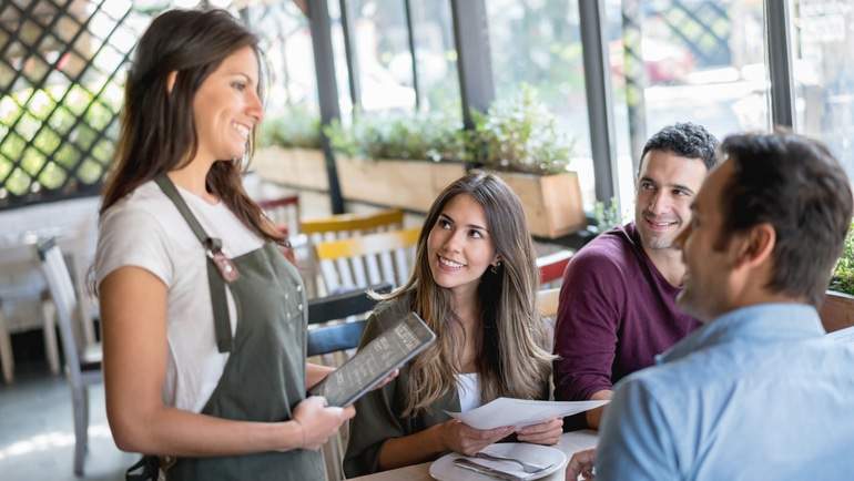 server taking diners orders with iPad POS