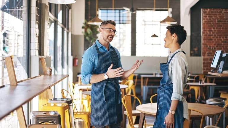 restaurant manager talking to staff