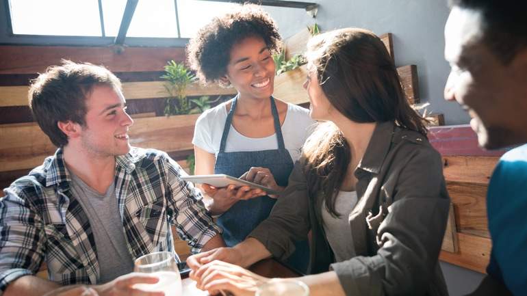 server taking diners orders with iPad POS