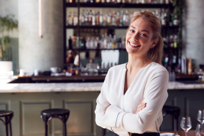 Woman smiling at an empty bar