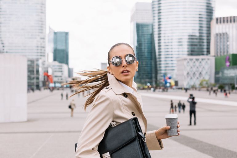 coffee customer dashing through the city with takeout coffee cup