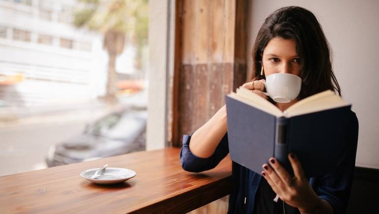 coffee shop customer reading a book