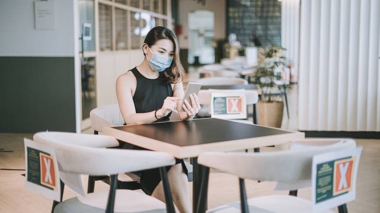 diner at a table wearing mask