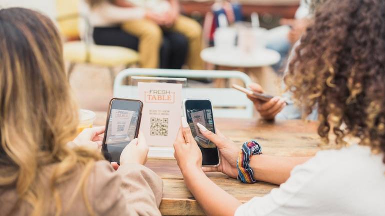 friends doing contactless ordering using their phones and a QR code