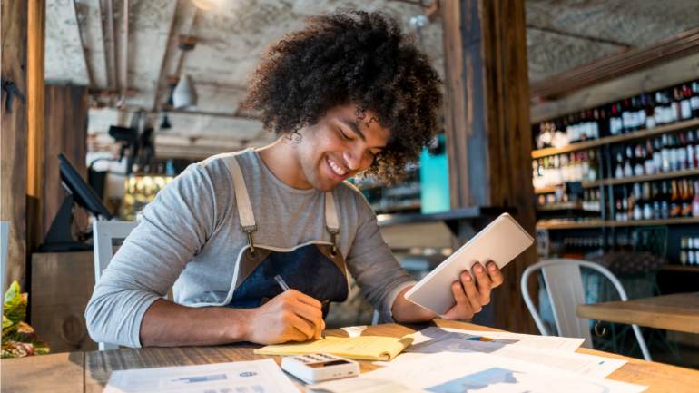 restaurant staff making notes from POS