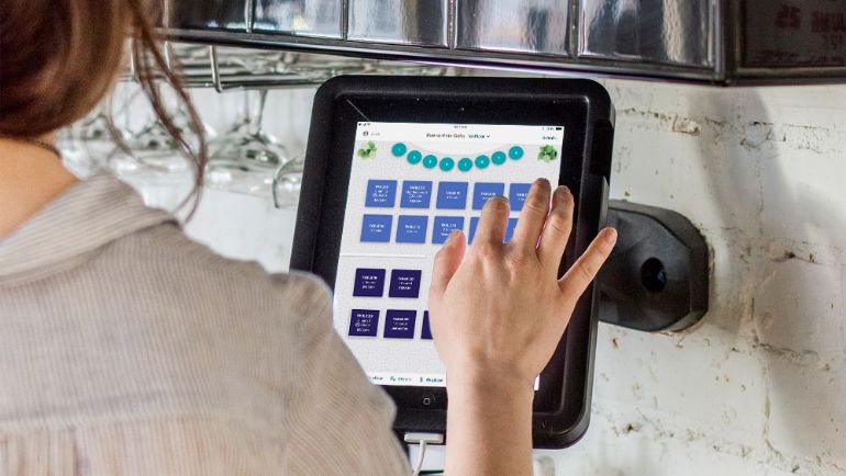 TouchBistro iPad point of sale with floor plan screen.