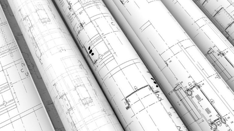 Rolls of architectural floor plans and blueprints.