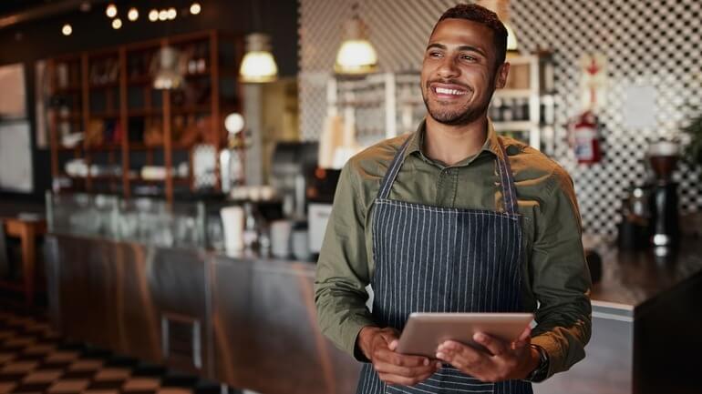 Male server holding a restaurant iPad tablet