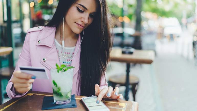 customer checking her loyalty program on her smart phone