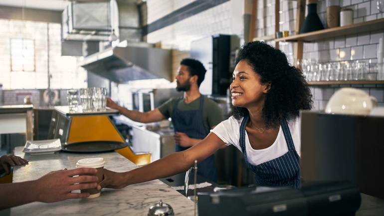 counter staff serving take out coffee