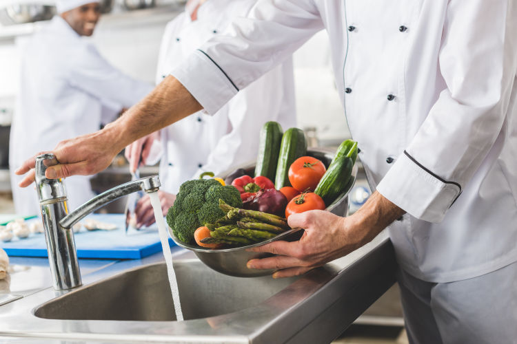 chef washing vegetables