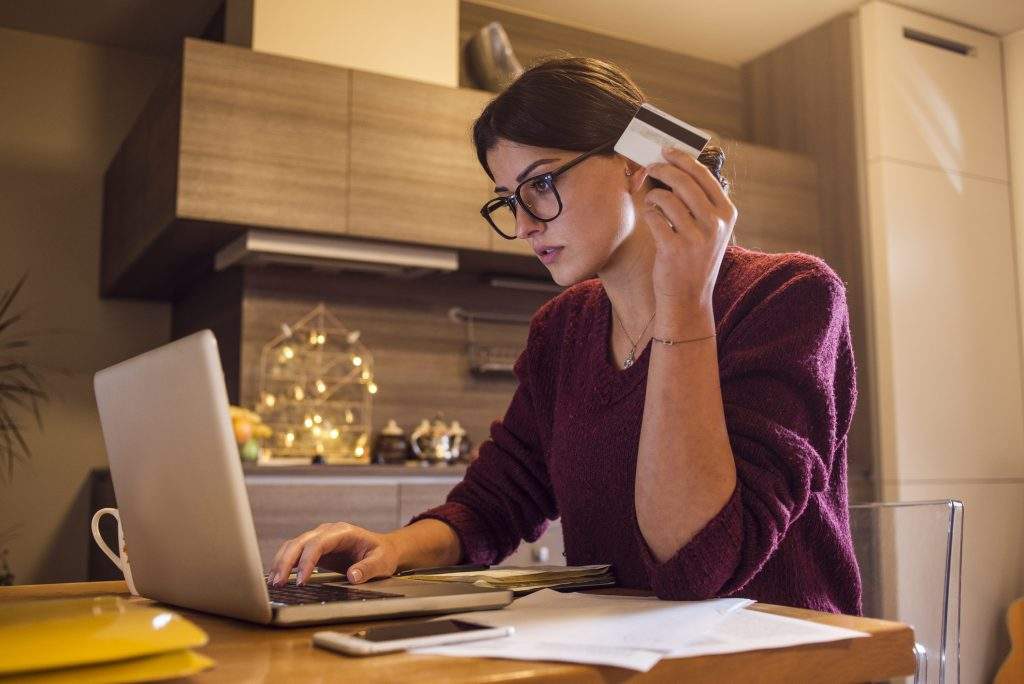 customer with credit card in hand ordering food online