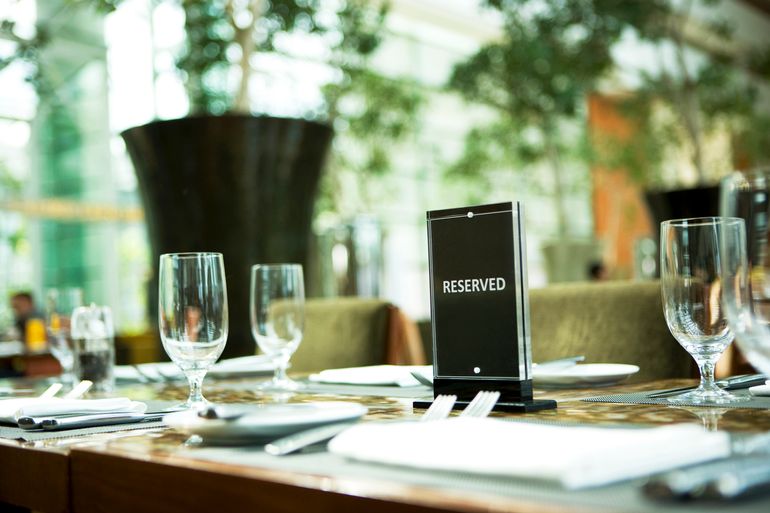 reserved sign atop a restaurant table