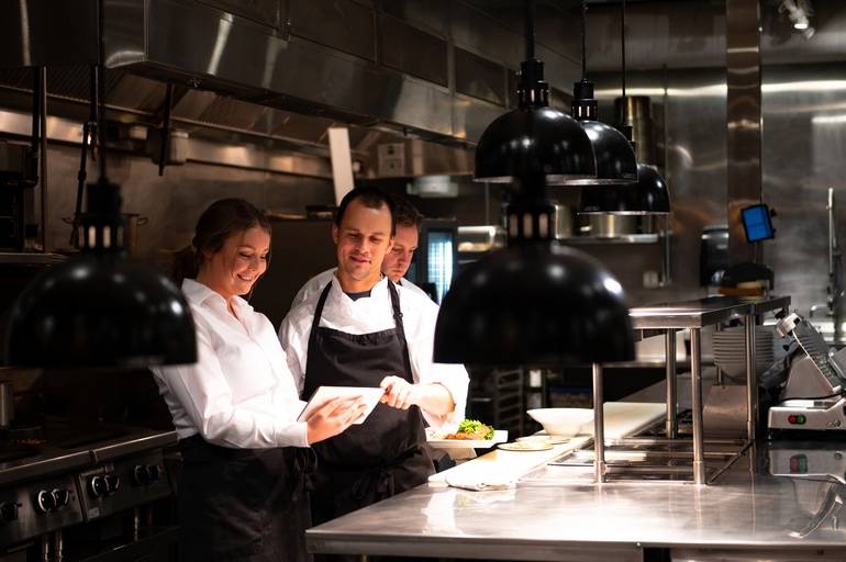 server and back of house staff reviewing an order on POS