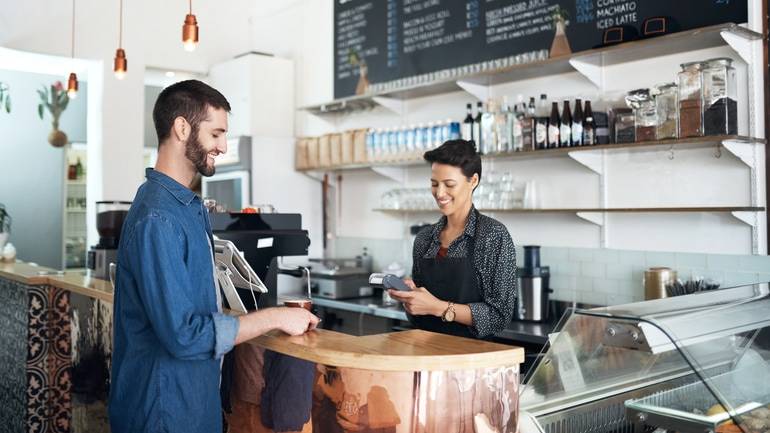 counter staff taking customer payment