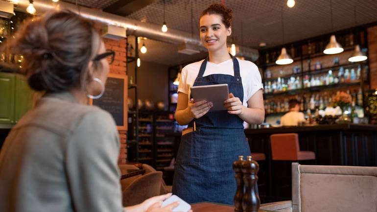 server taking order tableside with iPad POS