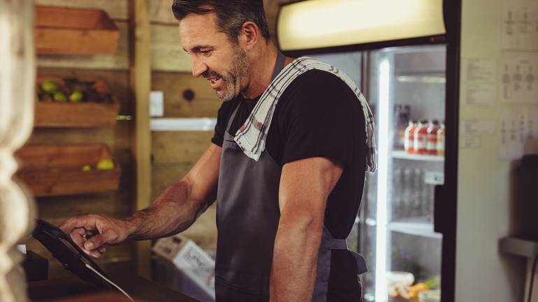 counter staff entering an order on POS