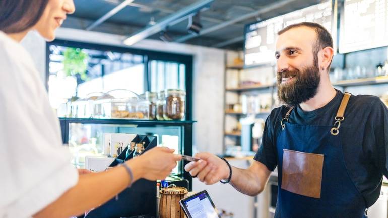 counter staff taking customer payment