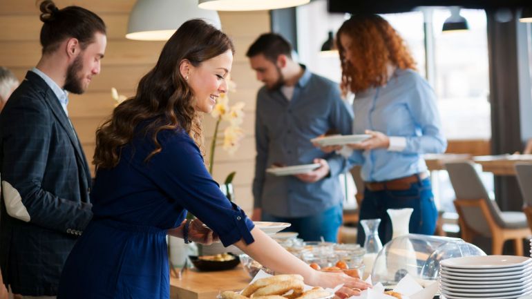 patrons helping themselves to a buffet-style meal