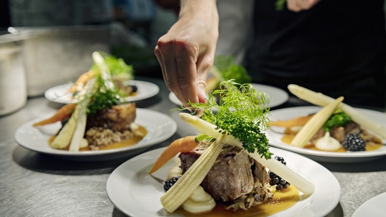 chef finishing plated entrees