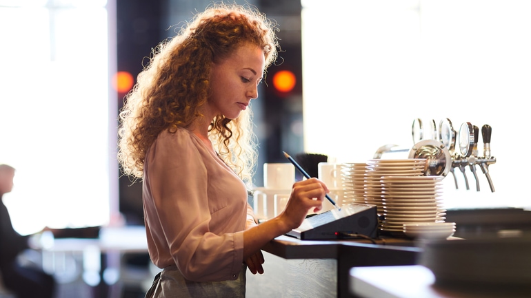 Waitress adding order in restaurant POS