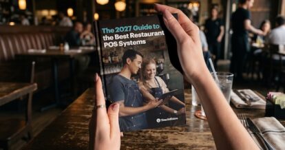 Cover of the Ultimate Guide to the Best Restaurant POS system booklet inside a busy restaurant.