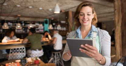 A female server smiling at her ipad