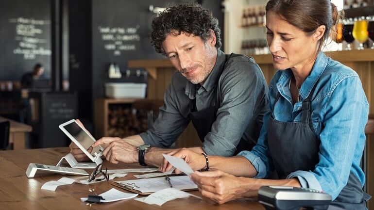 Restaurant owners reviewing operating costs.