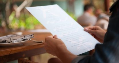 Woman reading a menu.