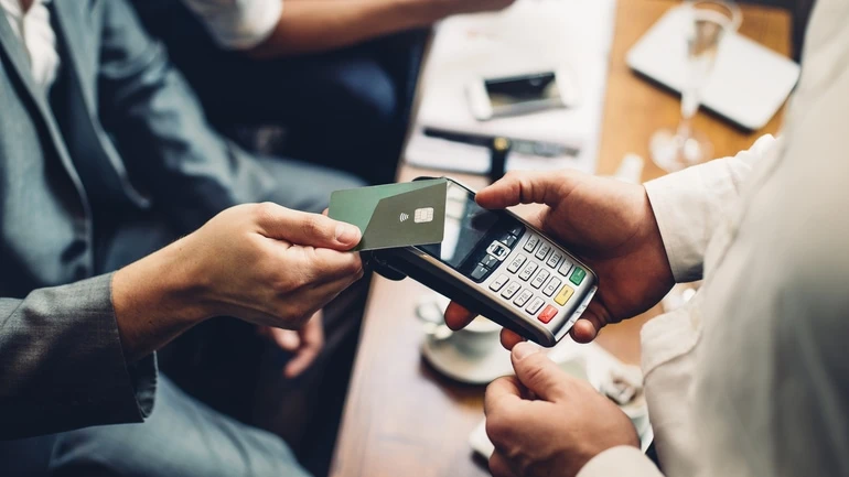 Man paying by tap at a restaurant.