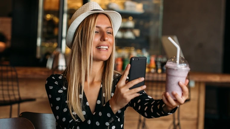 Food influencer taking a photo of a smoothie.