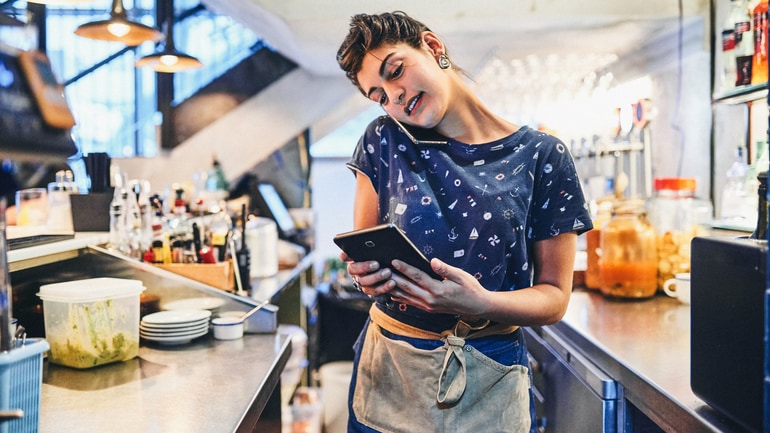 Restaurant owner taking a call-in order for takeout.