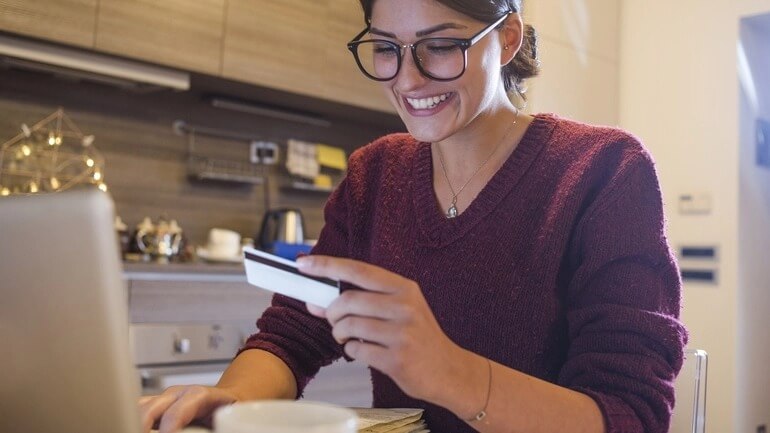 Woman using a gift card to make an online purchase.