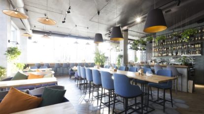 Dark, industrial bar inside a modern restaurant.