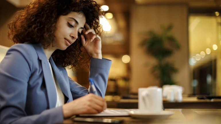 woman fills out survey form in a restaurant