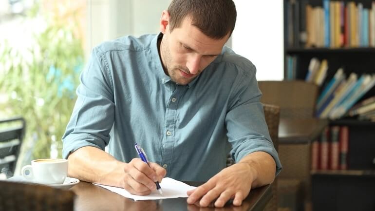 Man fills out survey form in a restaurant