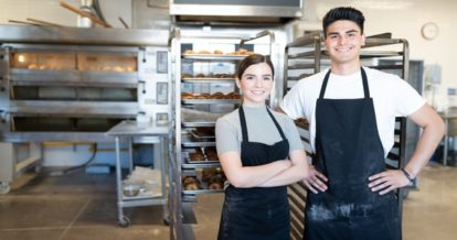 man and woman business bakery business owners stand in their bakery.