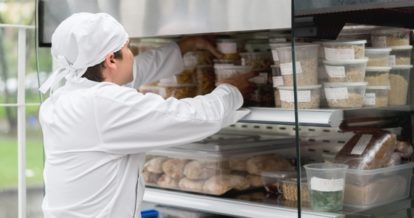 male restaurant worker checking inventory.