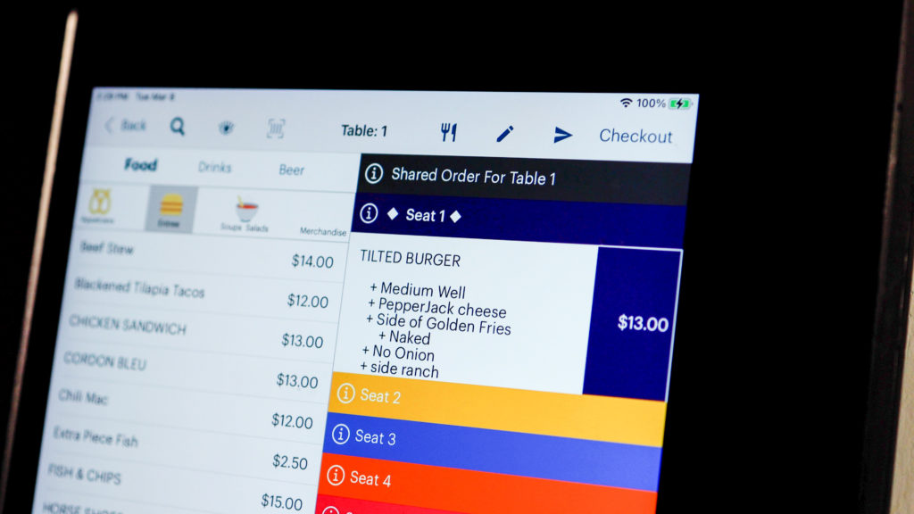 A screenshot of the TouchBistro POS that shows menu items being added to a bill.