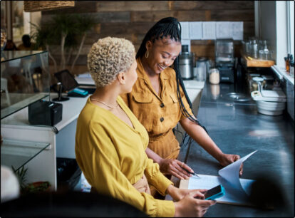 A mother and a daughter grabbing plates together