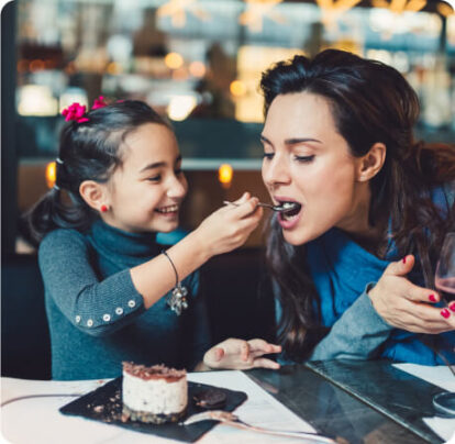 A daughter feeding her mom food