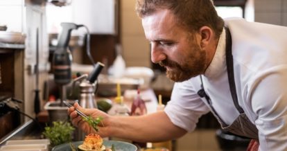 chef plating food carefully.