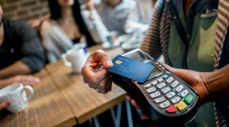 A person using integrated payments to pay for their meal at a restaurant.
