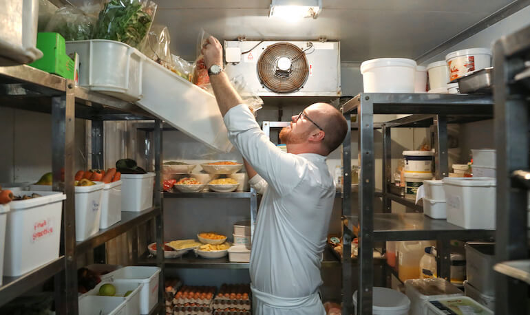 The head chef at a gourmet restaurant takes stock before dinner service in Somerset West, South Africa.
