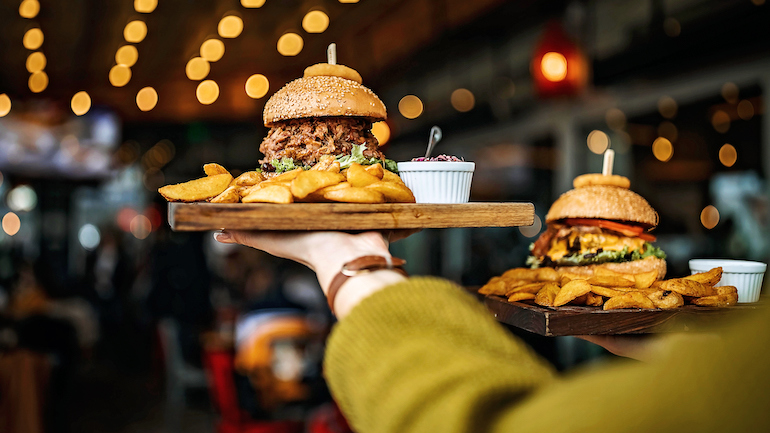 Woman carrying burger