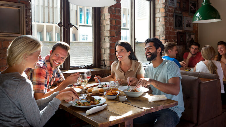 Group of friends enjoying a meal in a restaurant.