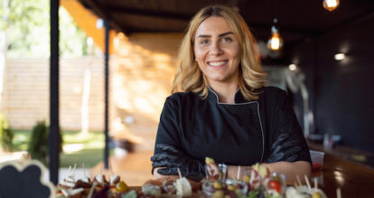 Restaurant worker woman with arms crossed.